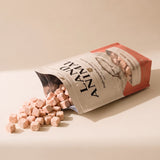Land Animal Salmon Bites for Cats treats spilling from pouch